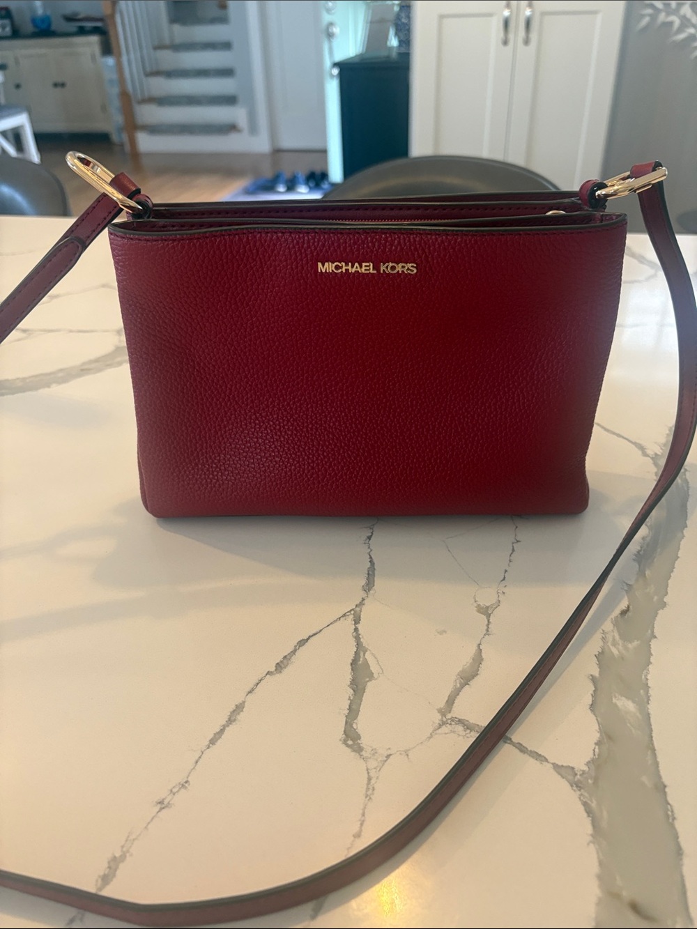 Michael Kors deep red medium crossbody bag with pebbled leather.